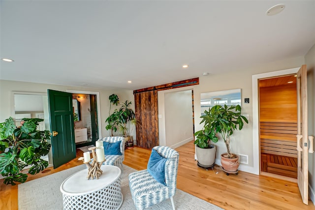 dining area featuring visible vents, recessed lighting, a barn door, light wood-style floors, and stairs