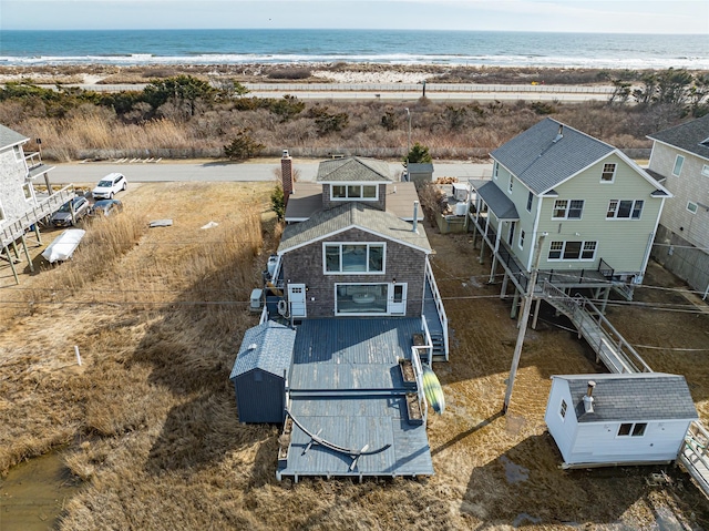 drone / aerial view featuring a view of the beach and a water view