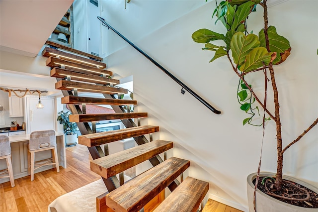 stairway featuring wood finished floors