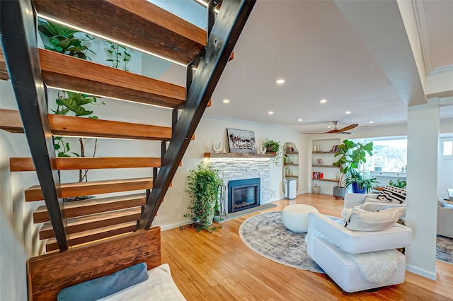 living room with wood finished floors, recessed lighting, a fireplace, ceiling fan, and stairs