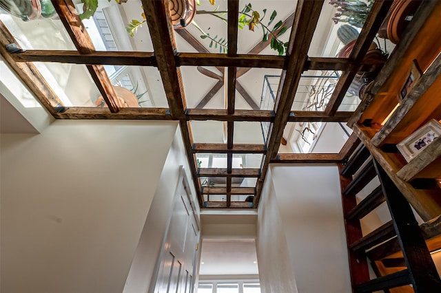 staircase featuring a towering ceiling