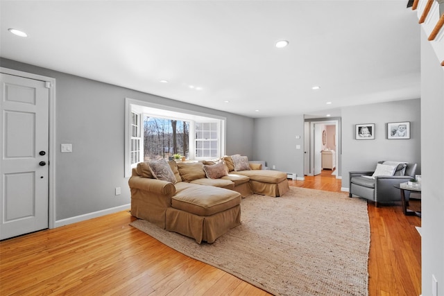 living room with recessed lighting, light wood-style flooring, and baseboards