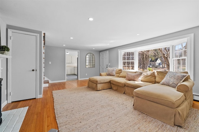 living room featuring light wood-style flooring, baseboards, a wealth of natural light, and recessed lighting