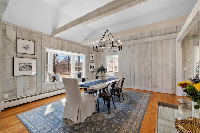 dining space featuring vaulted ceiling with beams, a chandelier, baseboard heating, and wood finished floors