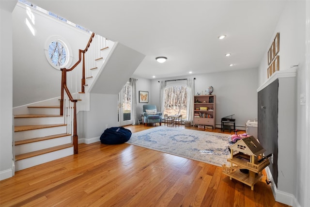 interior space with stairs, recessed lighting, wood finished floors, and baseboards