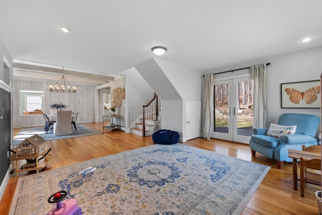 interior space featuring recessed lighting, french doors, an inviting chandelier, and wood finished floors