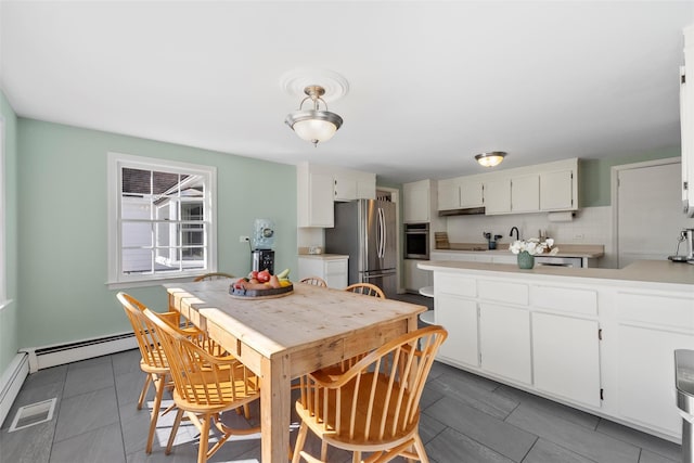 kitchen featuring appliances with stainless steel finishes, white cabinets, and light countertops