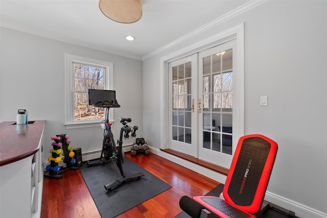 workout area with ornamental molding, french doors, baseboards, and wood finished floors