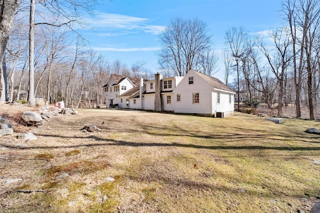 view of home's exterior featuring a yard and a chimney