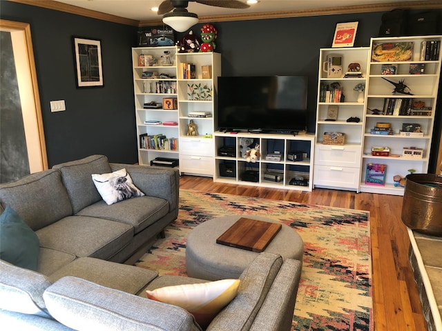 living area featuring ornamental molding and wood finished floors