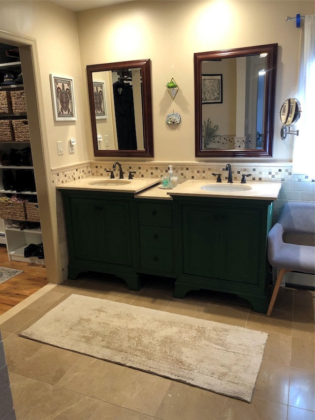 full bath featuring tile walls, wainscoting, and vanity