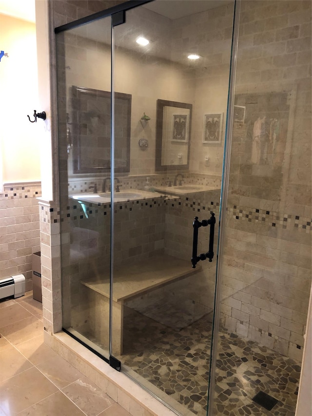 full bathroom featuring a shower stall, tile walls, and tile patterned floors