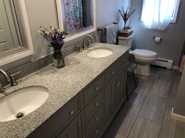 full bath with a baseboard radiator, a sink, toilet, and wood tiled floor