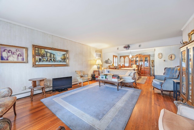 15744 97th St, Howard Beach, NY 11414 - living area with a baseboard heating unit, ornamental molding, and wood finished floors