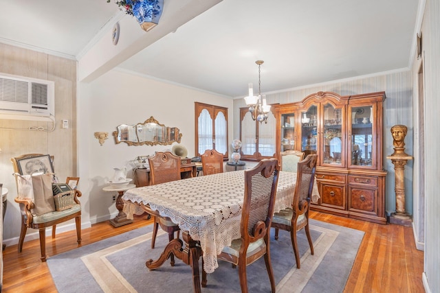 15744 97th St, Howard Beach, NY 11414 - dining area with light wood finished floors, baseboards, ornamental molding, a notable chandelier, and a wall mounted AC