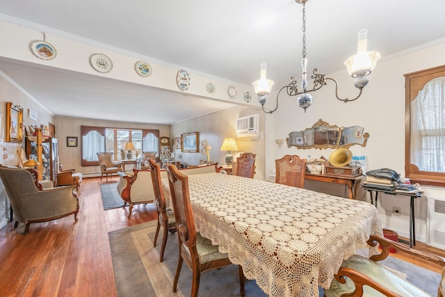 15744 97th St, Howard Beach, NY 11414 - dining room featuring an AC wall unit, crown molding, radiator heating unit, and wood finished floors