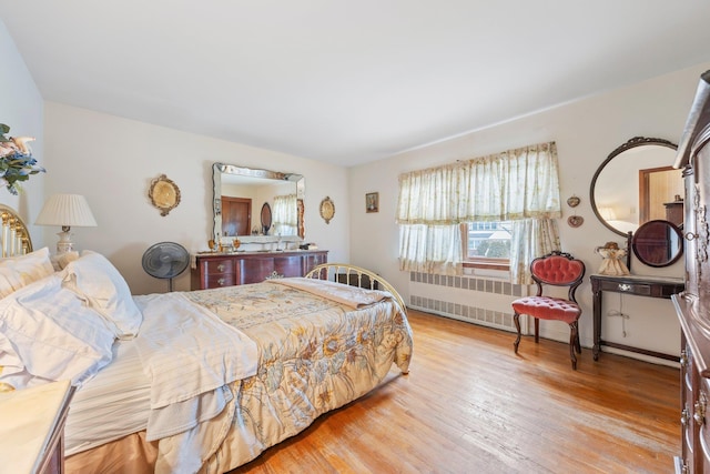 15744 97th St, Howard Beach, NY 11414 - bedroom featuring radiator heating unit and wood finished floors