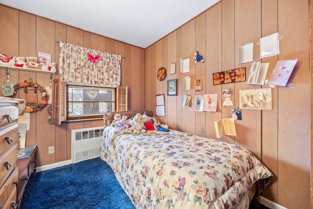 15744 97th St, Howard Beach, NY 11414 - bedroom with wooden walls, radiator heating unit, carpet, and baseboards