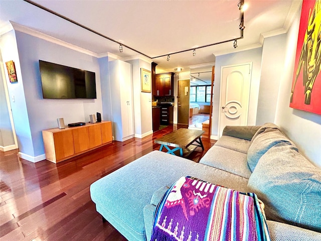 living area featuring track lighting, crown molding, baseboards, and dark wood-style flooring