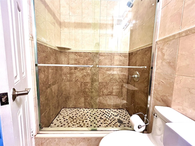 full bath featuring toilet and a stall shower