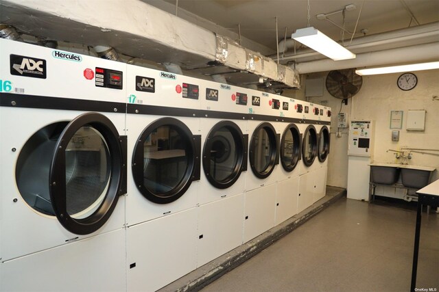 community laundry room featuring washing machine and clothes dryer