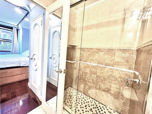 ensuite bathroom with a shower stall, crown molding, and ensuite bathroom