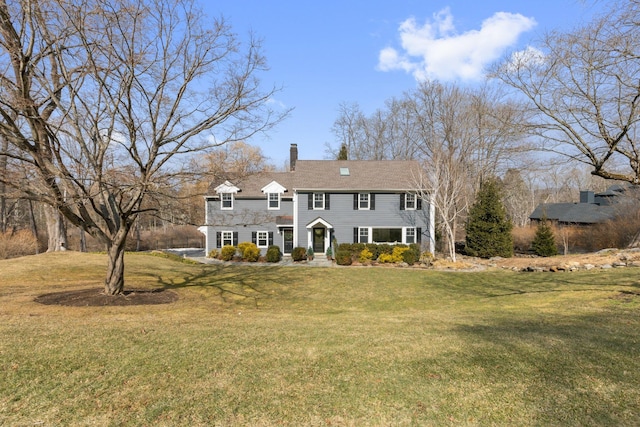 view of front of property with a front lawn and a chimney