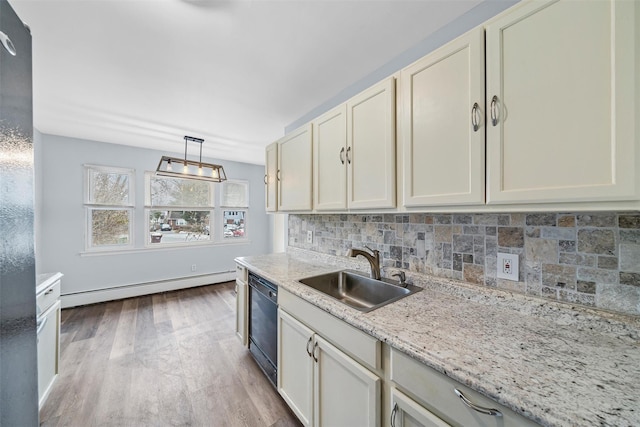 kitchen with a baseboard radiator, wood finished floors, a sink, black dishwasher, and decorative backsplash