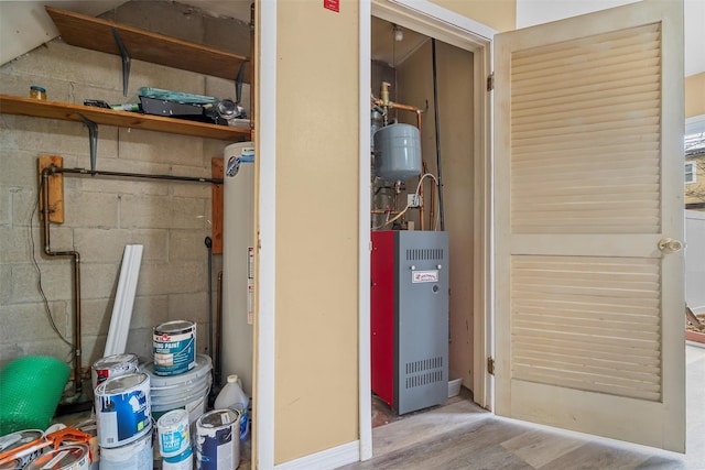 utility room featuring water heater and a heating unit