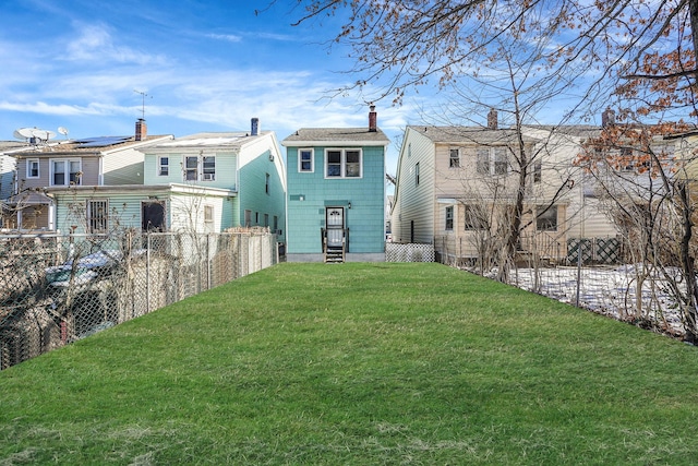 view of yard featuring entry steps and a fenced backyard