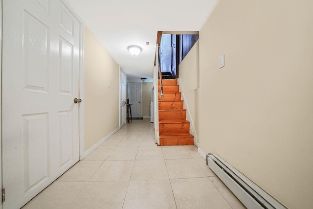 corridor featuring a baseboard heating unit, light tile patterned flooring, stairway, and baseboards