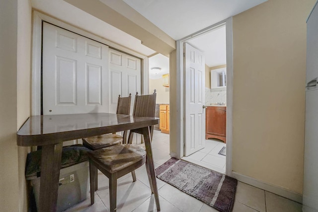 office area featuring baseboards and light tile patterned floors