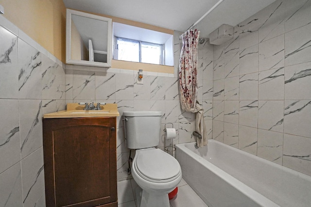 full bath with toilet, shower / tub combo, vanity, and tile walls