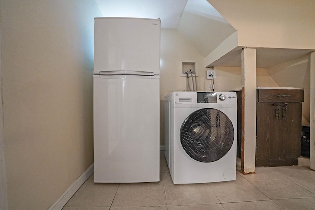 washroom with baseboards, washer / clothes dryer, and light tile patterned flooring