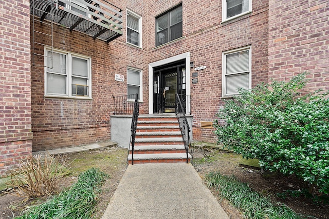 entrance to property featuring brick siding