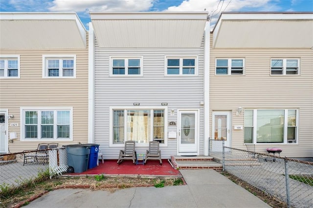 view of front of house with a patio and fence