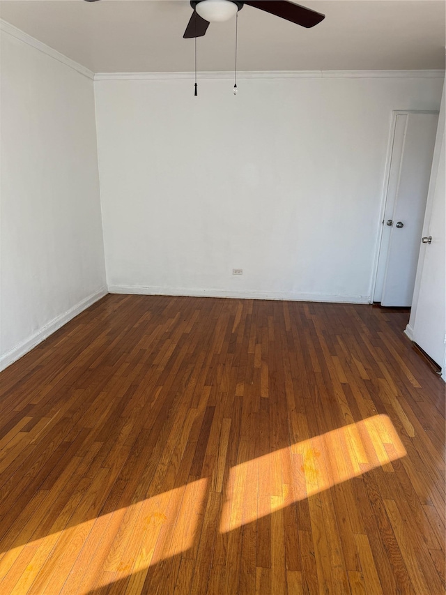 unfurnished room featuring hardwood / wood-style floors, baseboards, a ceiling fan, and crown molding