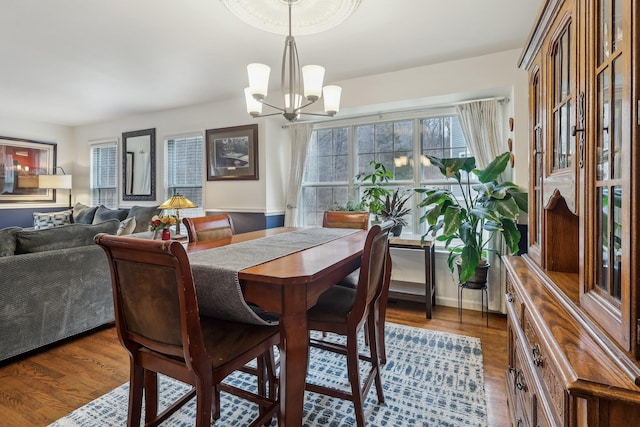 dining area featuring a chandelier and wood finished floors