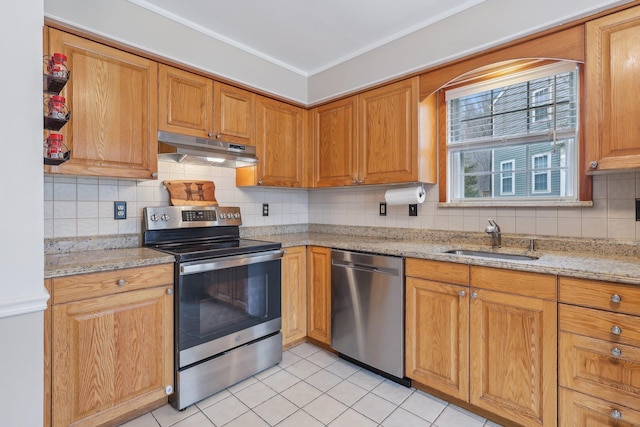 kitchen featuring decorative backsplash, appliances with stainless steel finishes, light tile patterned flooring, a sink, and under cabinet range hood