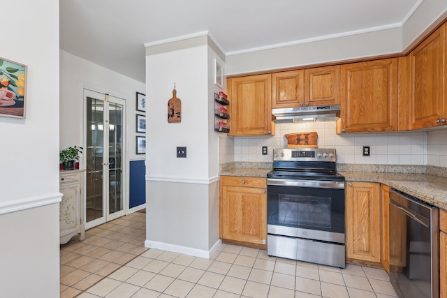 kitchen with appliances with stainless steel finishes, light tile patterned floors, under cabinet range hood, and tasteful backsplash