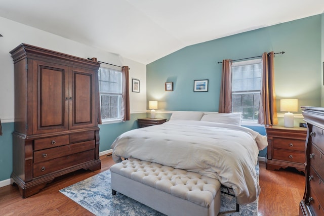 bedroom featuring vaulted ceiling, wood finished floors, and baseboards