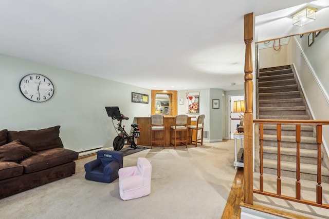 living room featuring stairs, a dry bar, a baseboard radiator, and carpet flooring