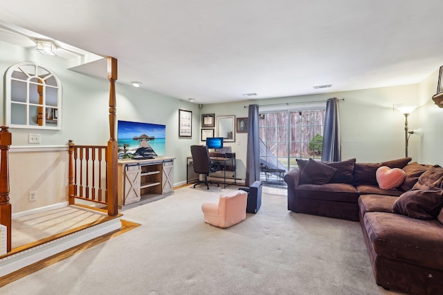 living area featuring carpet floors, visible vents, and baseboards