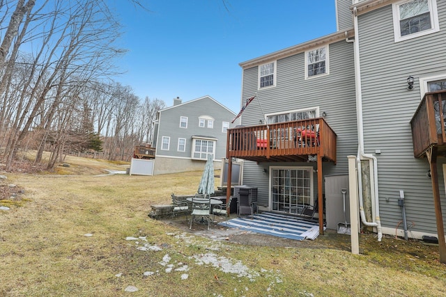 back of property featuring a patio, a lawn, and a wooden deck