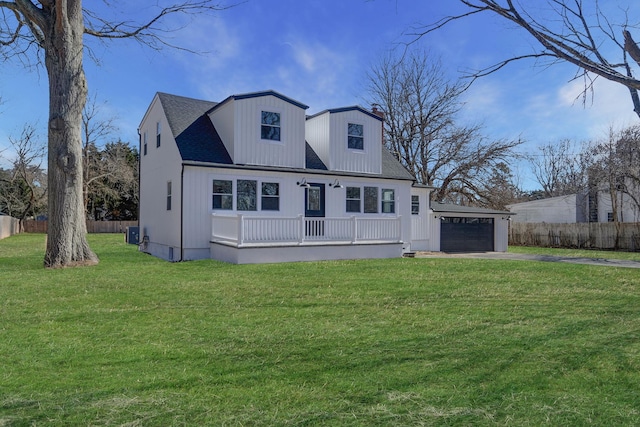 view of front of house featuring driveway, a front lawn, a porch, and fence