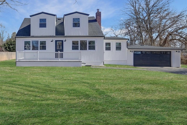 view of front of house featuring a garage, a shingled roof, a chimney, a porch, and a front yard