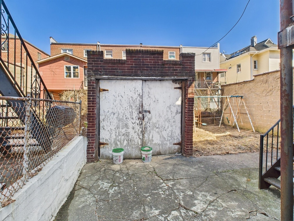 exterior space featuring a playground and fence