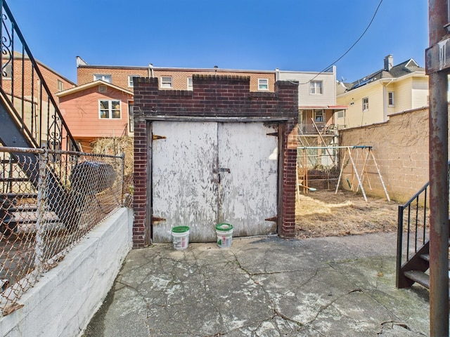 exterior space featuring a playground and fence