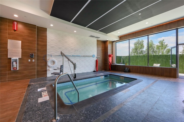 view of swimming pool with an indoor hot tub