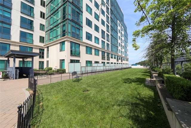 exterior space with fence and a lawn